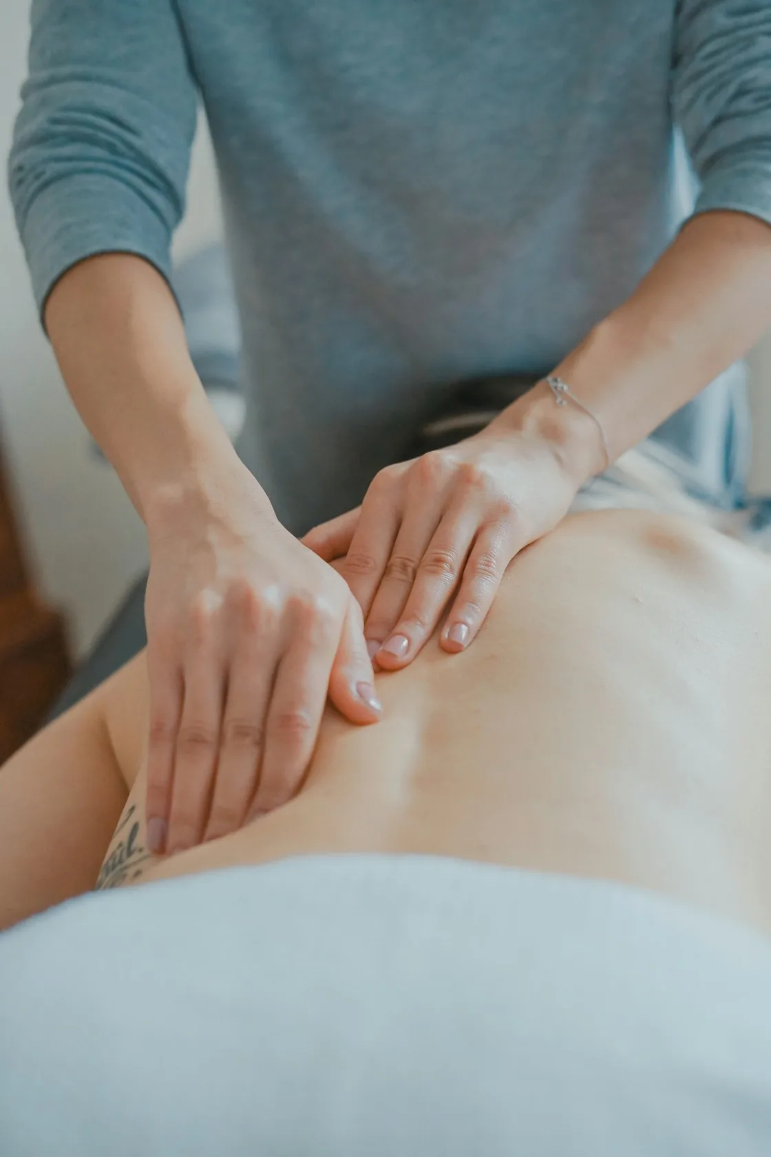Therapist massaging the upper back