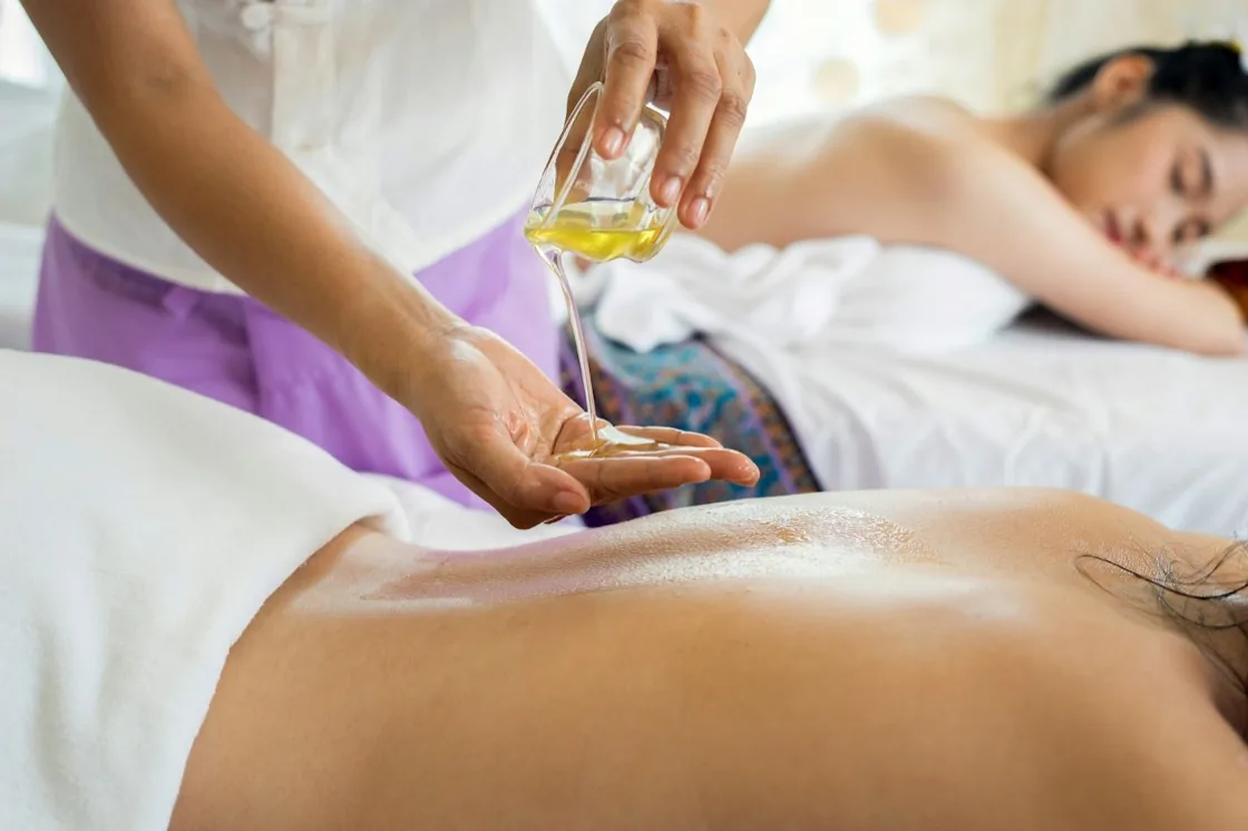 Massage oil poured before a body treatment