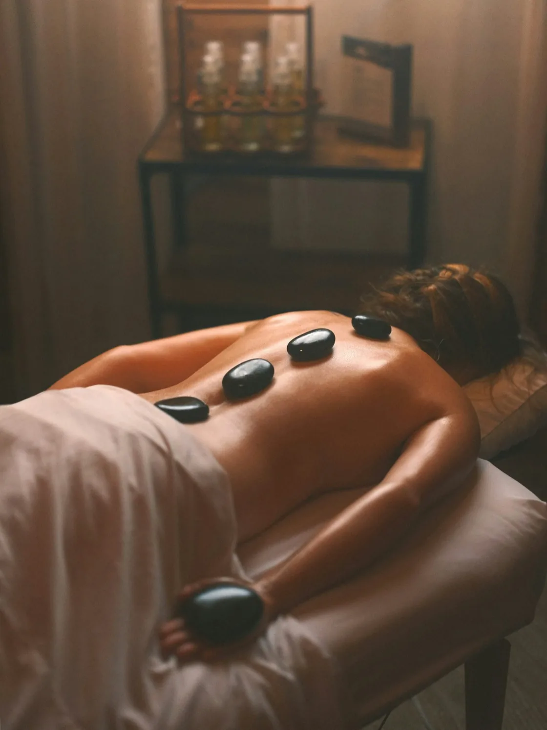 Hot stones placed along the spine during a massage